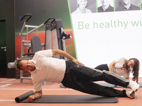 Lars Riedel, an Olympic champion, teaches exercise during the opening day of Medica 2022, a medical technology and health care exhibition in...