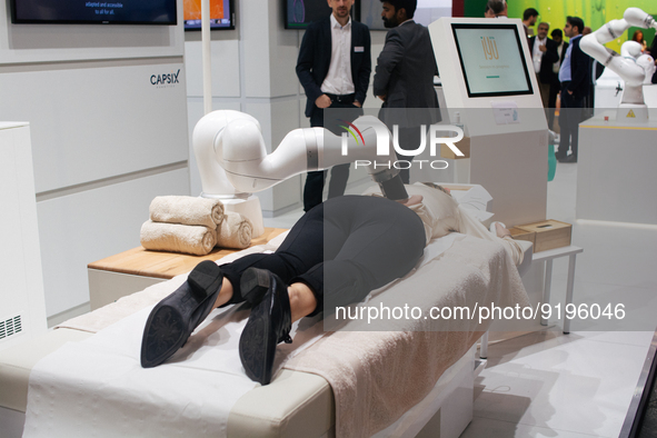 a fairgoer is seen trying out the massage robot  during the opening day of Medica 2022, a medical technology and health care exhibition in D...