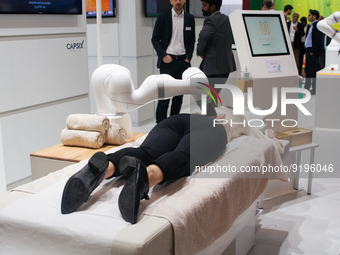 a fairgoer is seen trying out the massage robot  during the opening day of Medica 2022, a medical technology and health care exhibition in D...