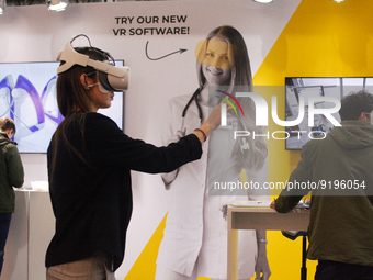 a fairgoer is seen trying out an augmented reality (AR) headset  during the opening day of Medica 2022, a medical technology and health care...