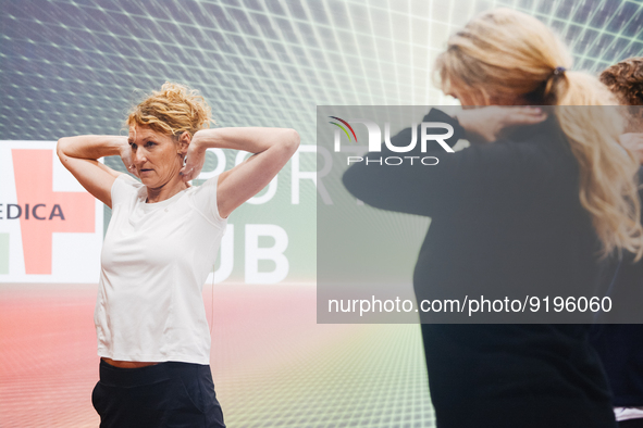 Heike Henkel, an Olympic champion, teaches exercise during the opening day of Medica 2022, a medical technology and health care exhibition i...