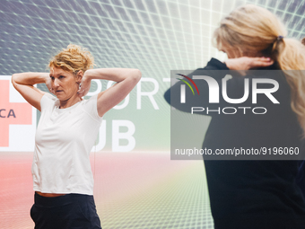 Heike Henkel, an Olympic champion, teaches exercise during the opening day of Medica 2022, a medical technology and health care exhibition i...