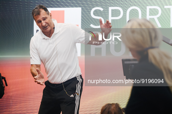 Lars Riedel, an Olympic champion, teaches exercise during the opening day of Medica 2022, a medical technology and health care exhibition in...