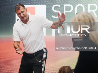 Lars Riedel, an Olympic champion, teaches exercise during the opening day of Medica 2022, a medical technology and health care exhibition in...