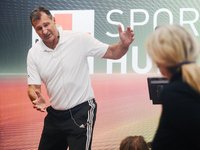 Lars Riedel, an Olympic champion, teaches exercise during the opening day of Medica 2022, a medical technology and health care exhibition in...