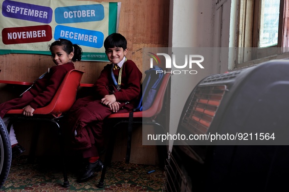 Students read inside a class room as heating facilities are installed at Ahmed public school in Baramulla Jammu and Kashmir India on 18 Nove...