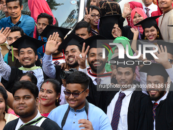 A group of graduates gather to expressing their delight of the Curzon hall at university area, on the 53th convocation of the students of Dh...