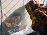 Rozina (19), is seen inside a mosquito net as she is under treatment for dengue fever at a special ward in Dhaka, Bangladesh on November 18,...