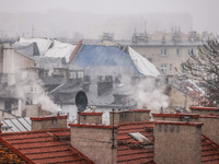 Smoke comes out of households' chimneys while the first snow is falling in Krakow, Poland, on November 24, 2022. Poland is one of the most p...