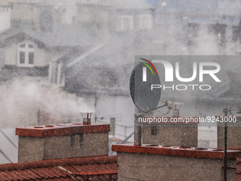 Smoke comes out of households' chimneys while the first snow is falling in Krakow, Poland, on November 24, 2022. Poland is one of the most p...