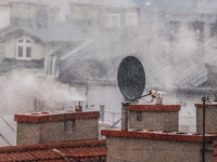 Smoke comes out of households' chimneys while the first snow is falling in Krakow, Poland, on November 24, 2022. Poland is one of the most p...