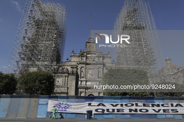 View of a banner outside the Metropolitan Cathedral in Mexico City's Zócalo on metal fences with slogans to mark the International Day for t...