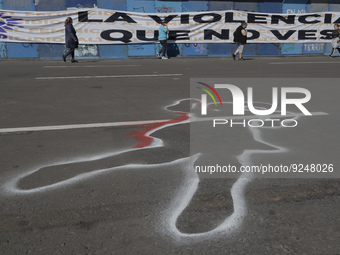 A silhouette painted on the ground in Mexico City's Zócalo to mark the International Day for the Elimination of Violence against Women. This...