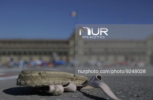 A woman's shoe on the ground in Mexico City's Zócalo to mark the International Day for the Elimination of Violence against Women. This day a...