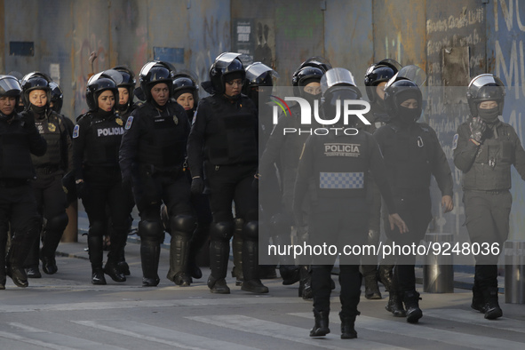 Police guard the streets of the Zócalo in Mexico City during the march of mothers of victims of femicides, relatives of disappeared persons...