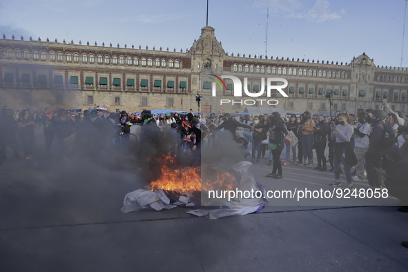 Members of the feminist Black Bloc burn banners and posters while demonstrating in Mexico City's Zócalo to mark the International Day for th...