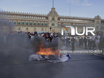 Members of the feminist Black Bloc burn banners and posters while demonstrating in Mexico City's Zócalo to mark the International Day for th...