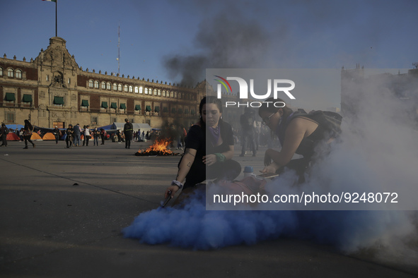 Members of the feminist Black Bloc burns a flare in the Zócalo in Mexico City to mark the International Day for the Elimination of Violence...