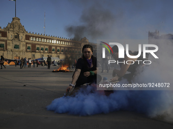 Members of the feminist Black Bloc burns a flare in the Zócalo in Mexico City to mark the International Day for the Elimination of Violence...