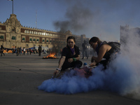 Members of the feminist Black Bloc burns a flare in the Zócalo in Mexico City to mark the International Day for the Elimination of Violence...