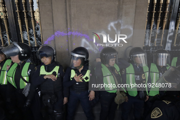 Police guard the Zocalo in Mexico City during the march of mothers of victims of femicides, relatives of disappeared persons and various fem...