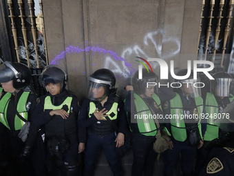 Police guard the Zocalo in Mexico City during the march of mothers of victims of femicides, relatives of disappeared persons and various fem...