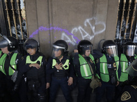 Police guard the Zocalo in Mexico City during the march of mothers of victims of femicides, relatives of disappeared persons and various fem...