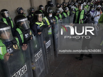 Police guard the Zocalo in Mexico City during the march of mothers of victims of femicides, relatives of disappeared persons and various fem...