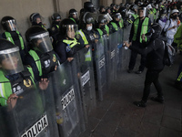 Police guard the Zocalo in Mexico City during the march of mothers of victims of femicides, relatives of disappeared persons and various fem...