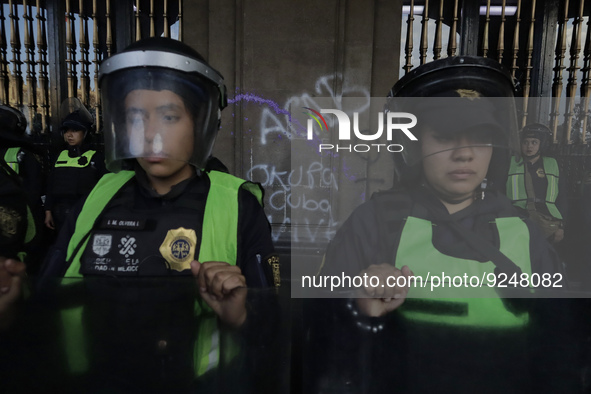 Police guard the Zocalo in Mexico City during the march of mothers of victims of femicides, relatives of disappeared persons and various fem...