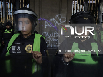 Police guard the Zocalo in Mexico City during the march of mothers of victims of femicides, relatives of disappeared persons and various fem...