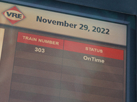 Commuter train statuses are listed on an electronic sign at the Virginia Railway Express L'Enfant Station in Washington, D.C. on November 29...