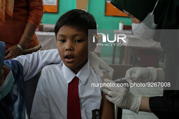 A Health workers inject students with the Diphtheria and Tetanus vaccines during child immunization at an elementary school in Lhokseumawe C...