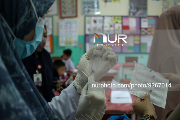 A health worker prepares an injection of the Diphtheria and Tetanus vaccines during child immunization at an elementary school in Lhokseumaw...