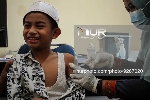 A Health workers inject students with the Diphtheria and Tetanus vaccines during child immunization at an elementary school in Lhokseumawe C...