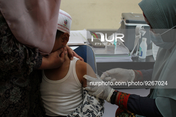 A Health workers inject students with the Diphtheria and Tetanus vaccines during child immunization at an elementary school in Lhokseumawe C...