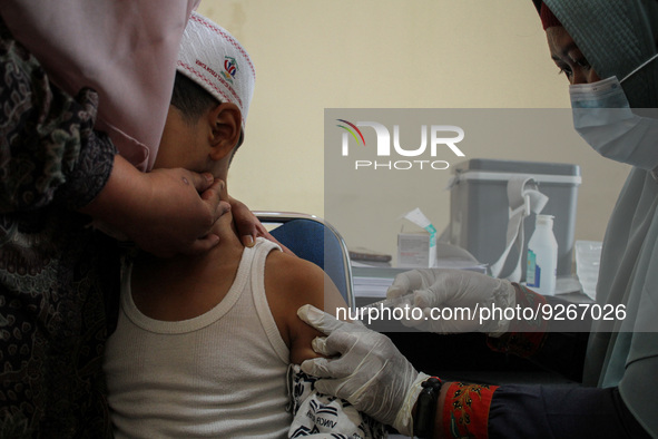 A Health workers inject students with the Diphtheria and Tetanus vaccines during child immunization at an elementary school in Lhokseumawe C...