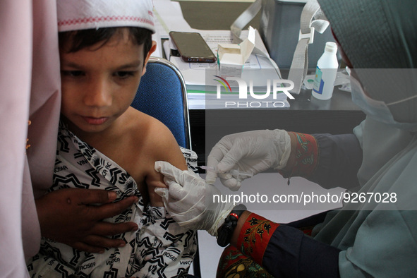 A Health workers inject students with the Diphtheria and Tetanus vaccines during child immunization at an elementary school in Lhokseumawe C...