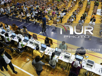 Thai people to  register to get vaccinated a COVID-19 booster at a vaccination center inside a stadium in Bangkok, Thailand, 03 December 202...