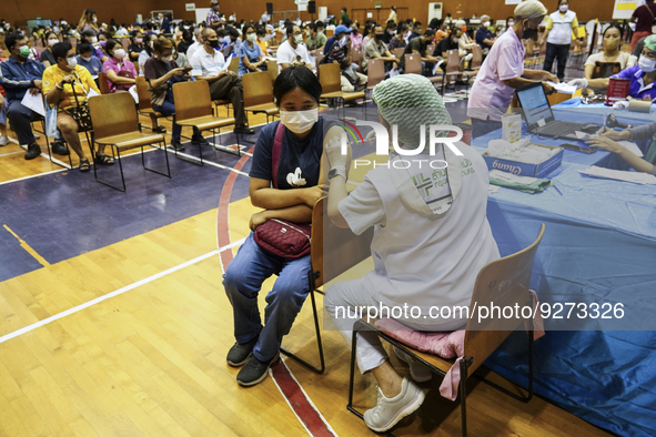 People receive doses of the Pfizer COVID-19 vaccine booster at a vaccination center inside a stadium in Bangkok, Thailand, 03 December 2022....