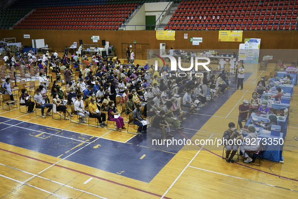 People receive doses of the Pfizer COVID-19 vaccine booster at a vaccination center inside a stadium in Bangkok, Thailand, 03 December 2022....