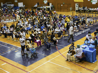 People receive doses of the Pfizer COVID-19 vaccine booster at a vaccination center inside a stadium in Bangkok, Thailand, 03 December 2022....