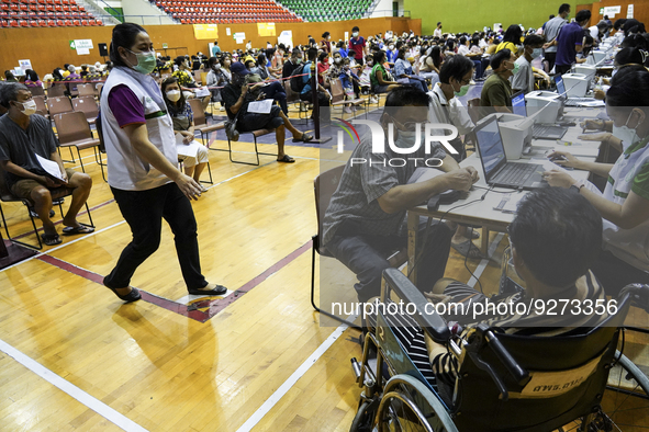 Thai people to  register to get vaccinated a COVID-19 booster at a vaccination center inside a stadium in Bangkok, Thailand, 03 December 202...