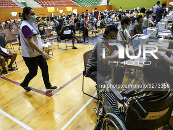 Thai people to  register to get vaccinated a COVID-19 booster at a vaccination center inside a stadium in Bangkok, Thailand, 03 December 202...