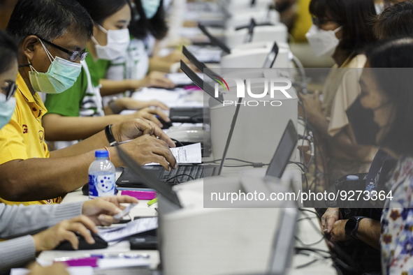 Thai people to  register to get vaccinated a COVID-19 booster at a vaccination center inside a stadium in Bangkok, Thailand, 03 December 202...