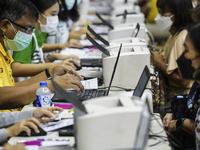 Thai people to  register to get vaccinated a COVID-19 booster at a vaccination center inside a stadium in Bangkok, Thailand, 03 December 202...