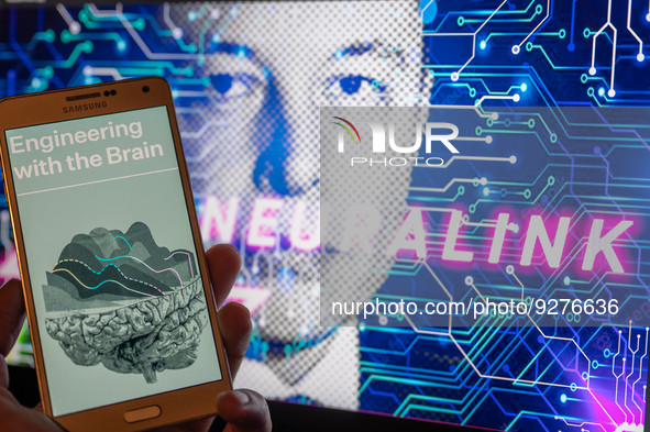 Neuralink logo displayed on mobil with founder Elon Musk seen on screen in the background. Neuralink Corporation is a neurotechnology compan...