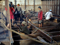 Myanmar workers work at a ship demolition site near Dala jetty in Yangon on December 7, 2022. (