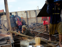 Myanmar workers work at a ship demolition site near Dala jetty in Yangon on December 7, 2022. (