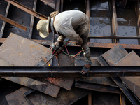 A worker works at a ship demolition site near Dala jetty in Yangon, Myanmar on December 7, 2022. (